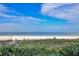 Picturesque beach view featuring lush foliage, white sand, and the tranquil blue waters of the ocean at 1520 Gulf Blvd # 1602, Clearwater Beach, FL 33767