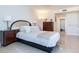 Bright bedroom featuring a comfortable bed, nightstands, and access to the bathroom at 1520 Gulf Blvd # 1602, Clearwater Beach, FL 33767