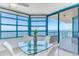 Bright dining room with a modern glass table and breathtaking ocean views at 1520 Gulf Blvd # 1602, Clearwater Beach, FL 33767