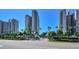 Elegant condominium entrance with palm trees, blue gate house and manicured landscaping at 1520 Gulf Blvd # 1602, Clearwater Beach, FL 33767