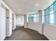 Hallway with carpet and several windows with a turquoise frame and a door to an elevator at 1520 Gulf Blvd # 1602, Clearwater Beach, FL 33767