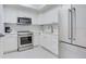 Bright white kitchen featuring modern appliances and ample counter space at 1520 Gulf Blvd # 1602, Clearwater Beach, FL 33767