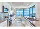 Bright kitchen featuring white cabinetry, granite counters, and ocean views at 1520 Gulf Blvd # 1602, Clearwater Beach, FL 33767