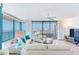 Bright living room featuring expansive windows with ocean views and comfortable seating at 1520 Gulf Blvd # 1602, Clearwater Beach, FL 33767