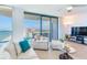 Bright living room featuring expansive windows with ocean views and comfortable seating at 1520 Gulf Blvd # 1602, Clearwater Beach, FL 33767