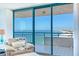 Bright living room with ocean views from the expansive sliding glass doors to the balcony at 1520 Gulf Blvd # 1602, Clearwater Beach, FL 33767