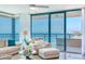 Bright living room featuring expansive windows with ocean views and comfortable seating at 1520 Gulf Blvd # 1602, Clearwater Beach, FL 33767