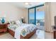 Cozy main bedroom with a full bed and access to a private balcony with ocean views at 1520 Gulf Blvd # 1602, Clearwater Beach, FL 33767