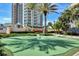 Exterior shot of a putting green in a residential community, with palm trees at 1520 Gulf Blvd # 1602, Clearwater Beach, FL 33767