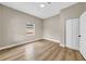 Simple bedroom with wood-look floors and neutral walls at 1740 W Cherry St, Tampa, FL 33607