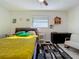 Bedroom with yellow bedding and a large window at 2606 46Th S St, Gulfport, FL 33711
