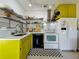 Modern kitchen with white cabinets, stainless steel appliances, and yellow accents at 2606 46Th S St, Gulfport, FL 33711