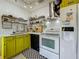 Modern kitchen with white cabinets, stainless steel appliances, and yellow accents at 2606 46Th S St, Gulfport, FL 33711