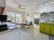 Modern kitchen with white cabinets, a breakfast nook, and green accents at 2606 46Th S St, Gulfport, FL 33711