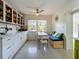 Bright kitchen with white cabinets, built in bench, and a ceiling fan at 2606 46Th S St, Gulfport, FL 33711