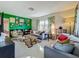 Bright living room featuring a gallery wall, comfy sofas, and a tiger rug at 2606 46Th S St, Gulfport, FL 33711