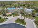 Community clubhouse surrounded by pools and palm trees at 27544 Kirkwood Cir, Wesley Chapel, FL 33544