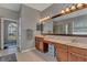 Double vanity bathroom with large mirror and wood cabinets at 27544 Kirkwood Cir, Wesley Chapel, FL 33544