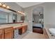 Elegant bathroom features a double vanity and access to the bedroom at 27544 Kirkwood Cir, Wesley Chapel, FL 33544