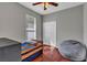 Cozy bedroom with a twin bed, large window and beanbag chair at 27544 Kirkwood Cir, Wesley Chapel, FL 33544
