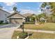 One-story house with two-car garage, mailbox, and manicured lawn at 27544 Kirkwood Cir, Wesley Chapel, FL 33544