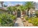 Welcoming entryway with lush landscaping and a paved walkway at 27544 Kirkwood Cir, Wesley Chapel, FL 33544