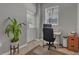Bright home office with desk, chair, and exterior access at 27544 Kirkwood Cir, Wesley Chapel, FL 33544