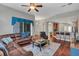 Living area with sectional sofa, hardwood floors, and ceiling fan at 27544 Kirkwood Cir, Wesley Chapel, FL 33544