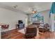 Gathering room with leather furniture, hardwood floors, and large windows at 27544 Kirkwood Cir, Wesley Chapel, FL 33544