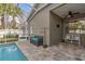 Screened pool area with tiled deck and seating at 27544 Kirkwood Cir, Wesley Chapel, FL 33544