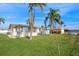 Large backyard with a shed, patio furniture and a grassy lawn at 3034 Domino Dr, Holiday, FL 34691