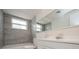 Bathroom with gray tile, a white vanity, and a bathtub at 3034 Domino Dr, Holiday, FL 34691