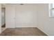 Simple bedroom with carpet, window, and door at 3034 Domino Dr, Holiday, FL 34691