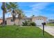 Cute ranch home with a large yard, palm trees, and a one car garage at 3034 Domino Dr, Holiday, FL 34691
