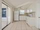 White kitchen with appliances and sliding door to patio at 3034 Domino Dr, Holiday, FL 34691