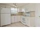 White kitchen features ample cabinets and countertop space at 3034 Domino Dr, Holiday, FL 34691