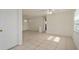 Living room features tile floors and access to front door at 3034 Domino Dr, Holiday, FL 34691