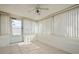 Bright sunroom features tile flooring, window blinds, and access to the backyard at 3034 Domino Dr, Holiday, FL 34691