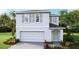 Two-story house with gray siding, gray shutters, and a two-car garage at 36101 Sunflower Hill Dr, Zephyrhills, FL 33541
