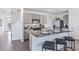 Modern kitchen with gray cabinets, granite countertops, and stainless steel appliances at 36101 Sunflower Hill Dr, Zephyrhills, FL 33541
