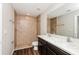 Bathroom with double vanity, large shower, and dark brown cabinets at 3843 Laslo Ave, North Port, FL 34287