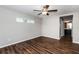 Spacious bedroom with wood-look flooring, ceiling fan and access to bathroom at 3843 Laslo Ave, North Port, FL 34287