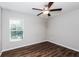 Spacious bedroom with wood-look floors and a window with blinds at 3843 Laslo Ave, North Port, FL 34287