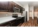 Modern kitchen with dark cabinetry, stainless steel appliances, and breakfast bar at 3843 Laslo Ave, North Port, FL 34287