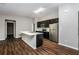 Modern kitchen with dark cabinetry, stainless steel appliances, and breakfast bar at 3843 Laslo Ave, North Port, FL 34287