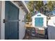 Property features two storage sheds, one with teal doors at 416 Country Club Dr, Oldsmar, FL 34677