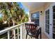 Private balcony with table and chairs, overlooking green space at 443 Pinellas Bayway S # 105, Tierra Verde, FL 33715