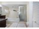Bathroom with soaking tub, shower, and dark vanity at 443 Pinellas Bayway S # 105, Tierra Verde, FL 33715