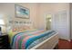 Main bedroom with white bed frame and colorful bedding at 443 Pinellas Bayway S # 105, Tierra Verde, FL 33715