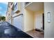 Unit 105 exterior entrance with garage and walkway at 443 Pinellas Bayway S # 105, Tierra Verde, FL 33715